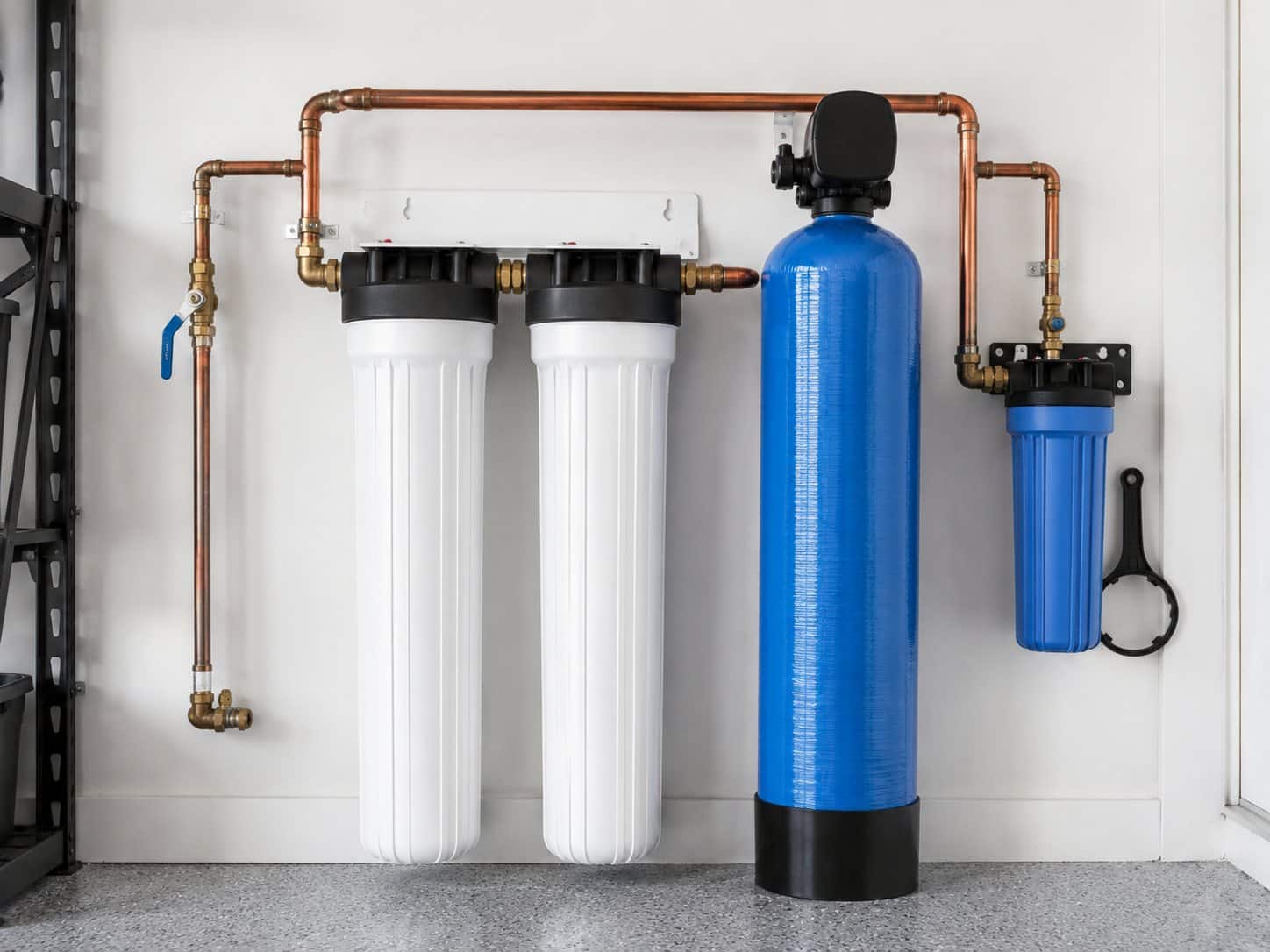 Water conditioning and filtration system installed on a garage wall