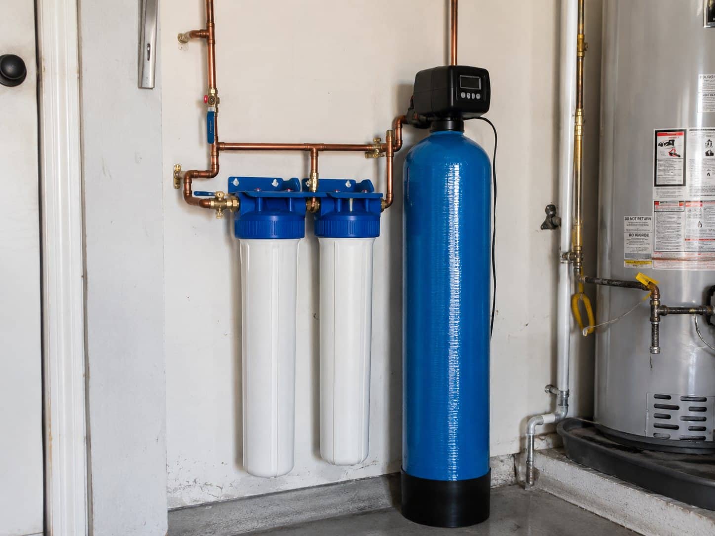 Whole-home water filtration system with filter housings and mineral tank