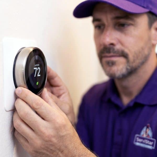 ServiStar technician installing a smart thermostat