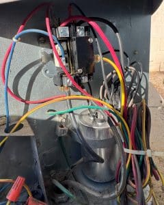 HVAC condenser control panel showing contactor, dual run capacitor and wiring
