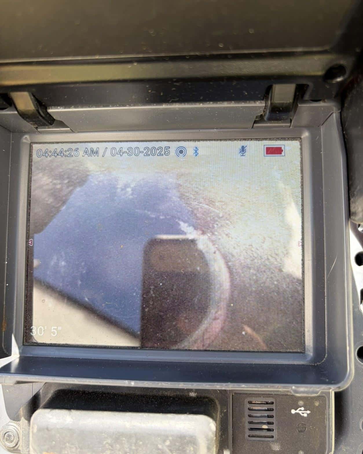 Sewer camera monitor showing pipe blockage at 30 feet 5 inches inside a residential cast iron lateral